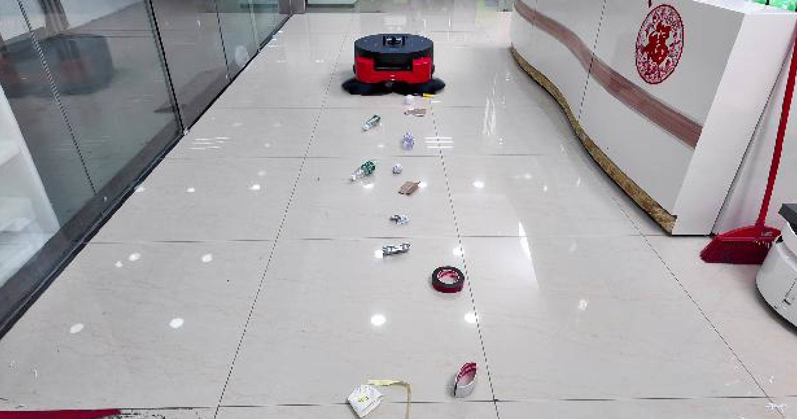 ATEAGO S1M Floor Sweeping Robot HERO autonomously cleaning debris in a commercial hallway, showcasing its industrial efficiency.
