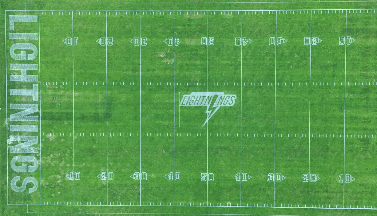 Aerial view of sports field with robotic lawn mower marking