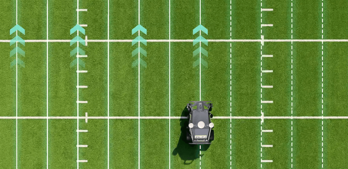 Robotic mower on football field