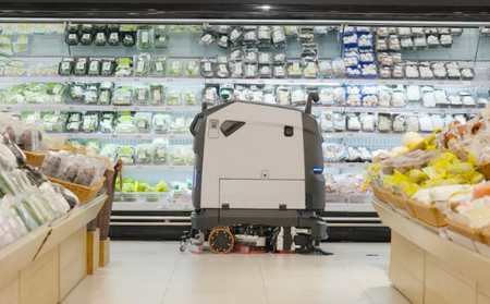 Robotic cleaning machine operating in grocery store aisle